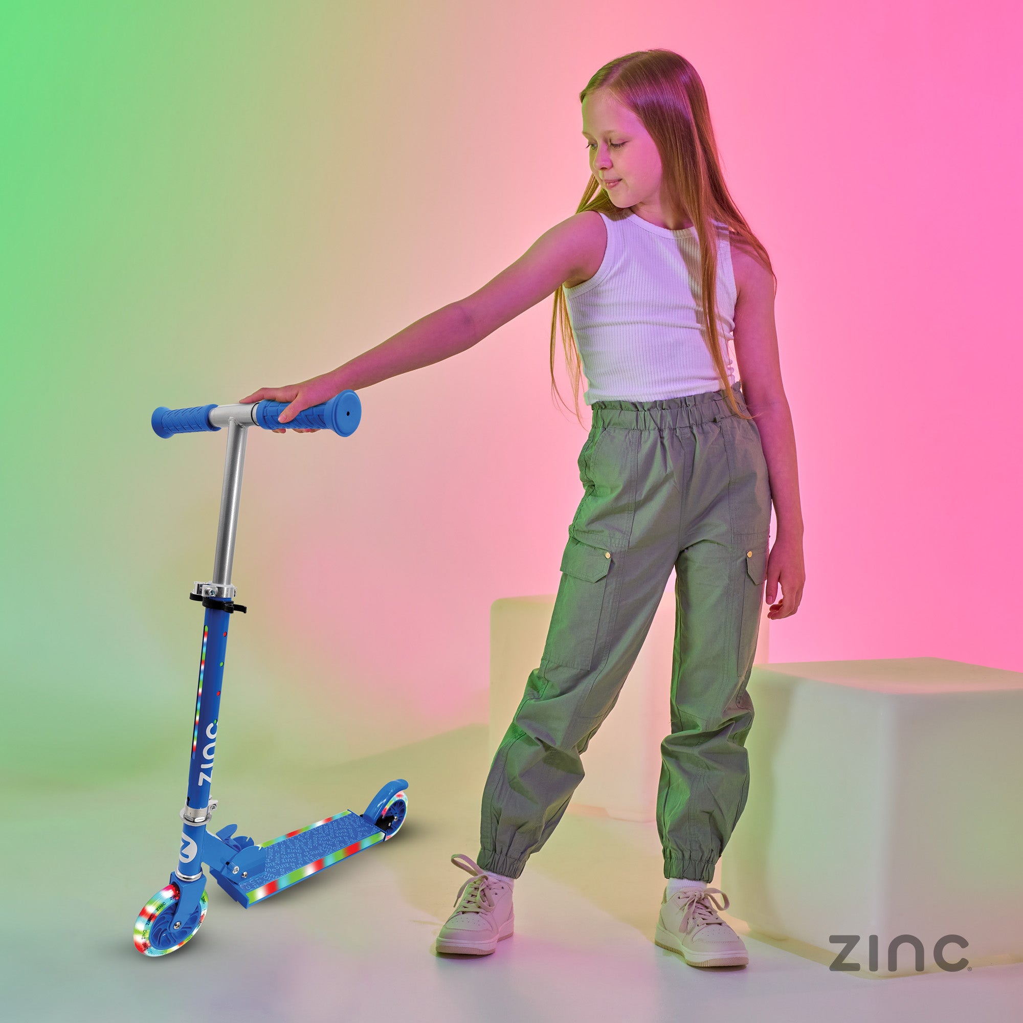 Girl holding a blue scooter against a colourful gradient background with 'Zinc' branding.
