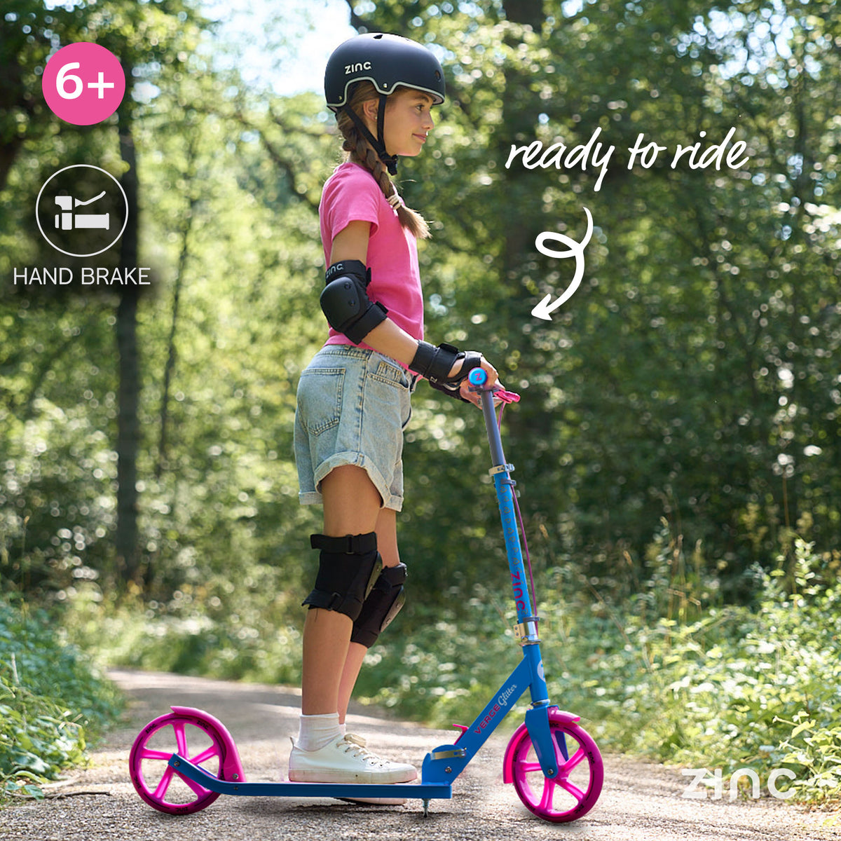 Zinc Big Wheel Folding Verge Pro Glitter Scooter in the woods being used by a girl in Zinc Scooter Helmet with copy reading 'Ready to ride'