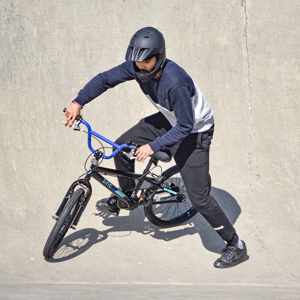 Young rider on ZINC BMX bike at skate park demonstrating bike capabilities