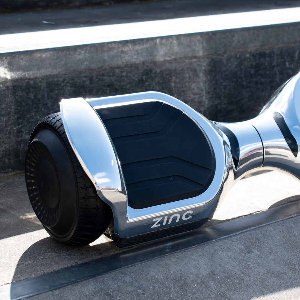 Chrome hoverboard platform showing anti-slip grip pads and Bluetooth connectivity for music playback