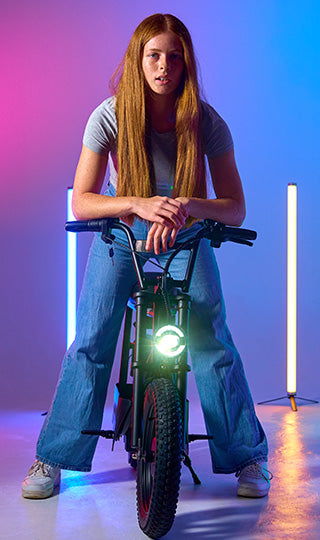 Teenage girl leaning on her Zinc Sprintr electric scooter.