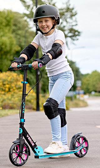 Child riding the Zinc Verge Pro scooter whilst wearing full protective gear.