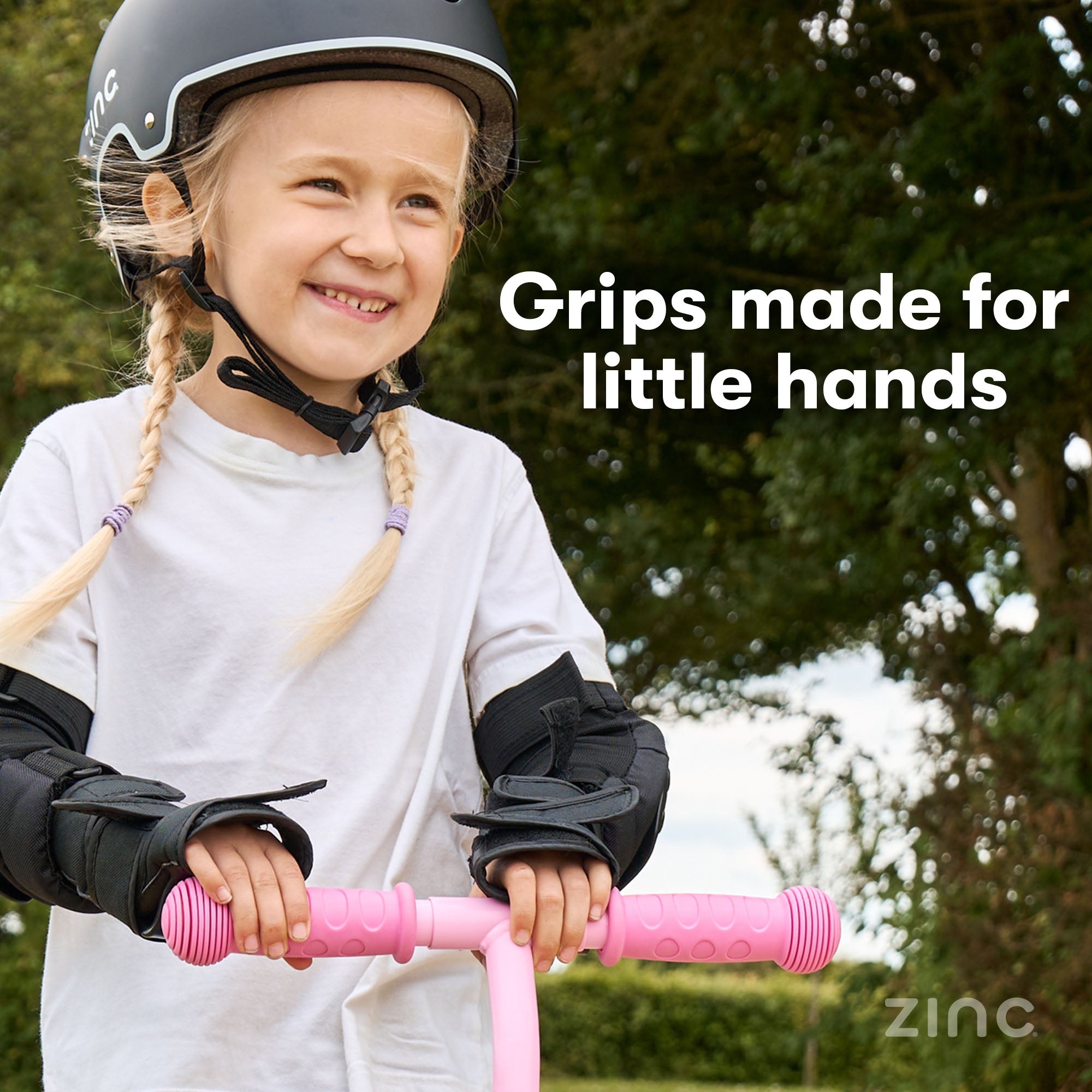 Little girl smiling while riding Zinc My First 3-in-1 Kids Scooter with close-up detail of hand grips showing proper grip positioning