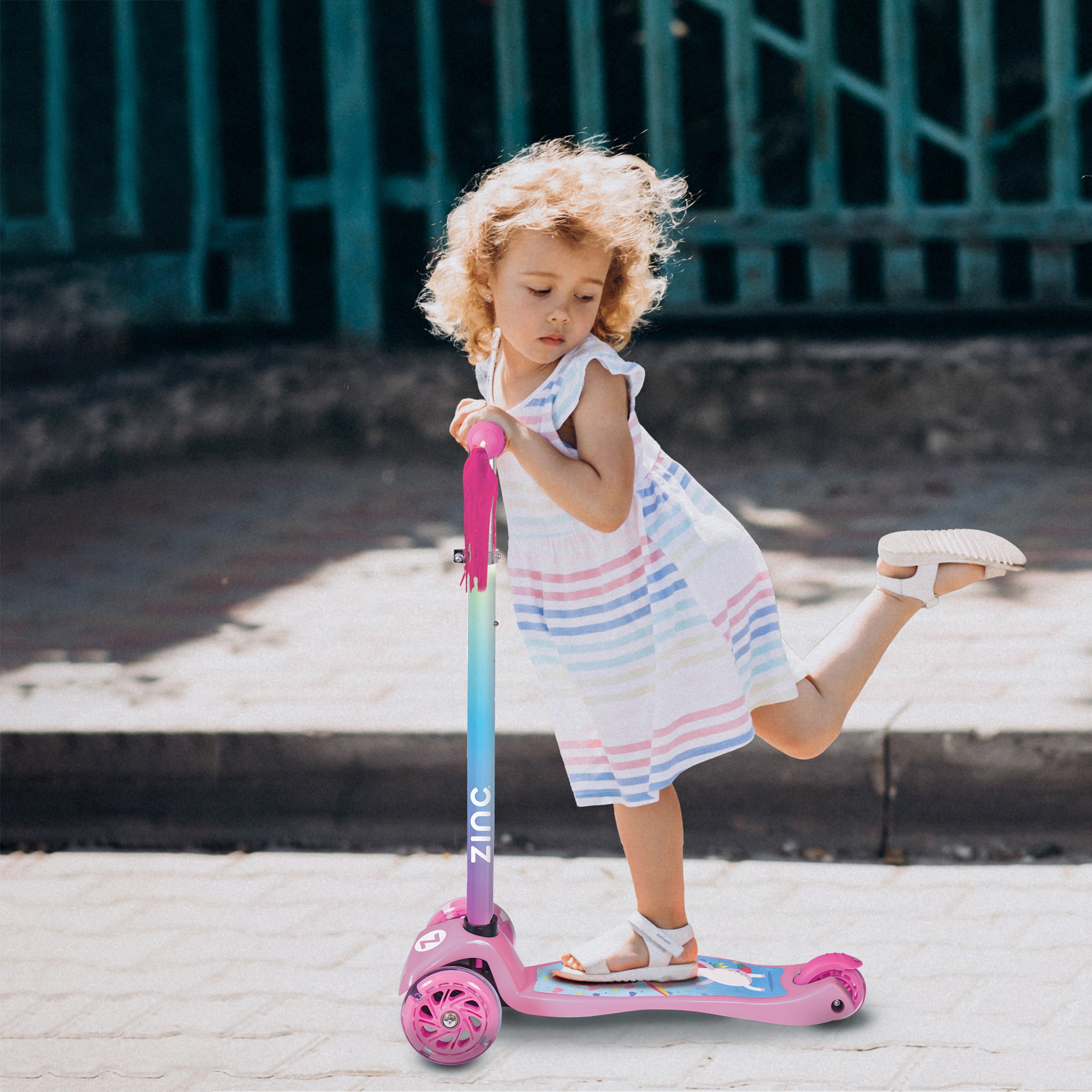Little girl scooting on a Zinc Three Wheeled Explorer Non Folding unicorn Scooter  