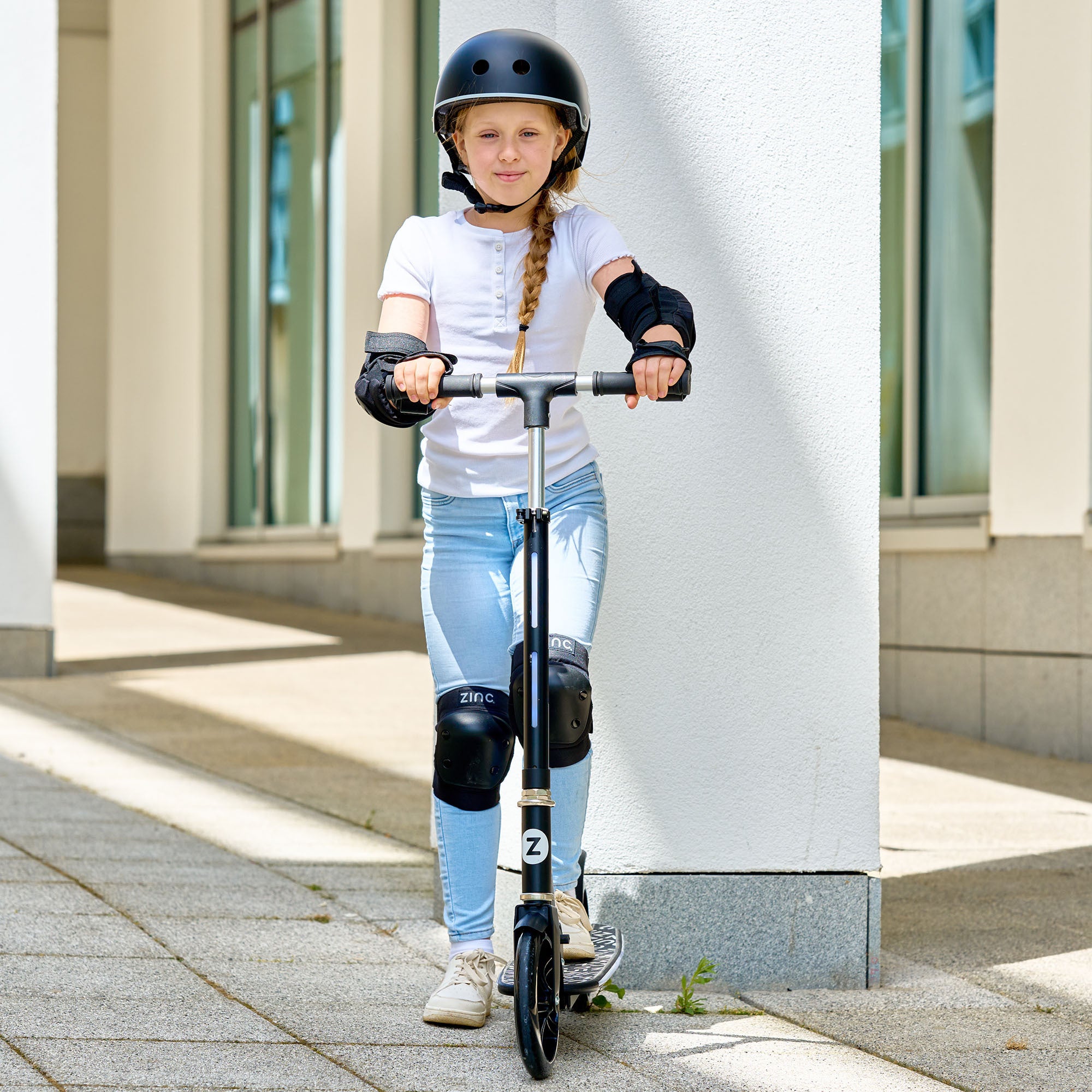 Girl riding Zinc Brillz Light Up Big Wheeled Folding Scooter - Head-on Action Shot