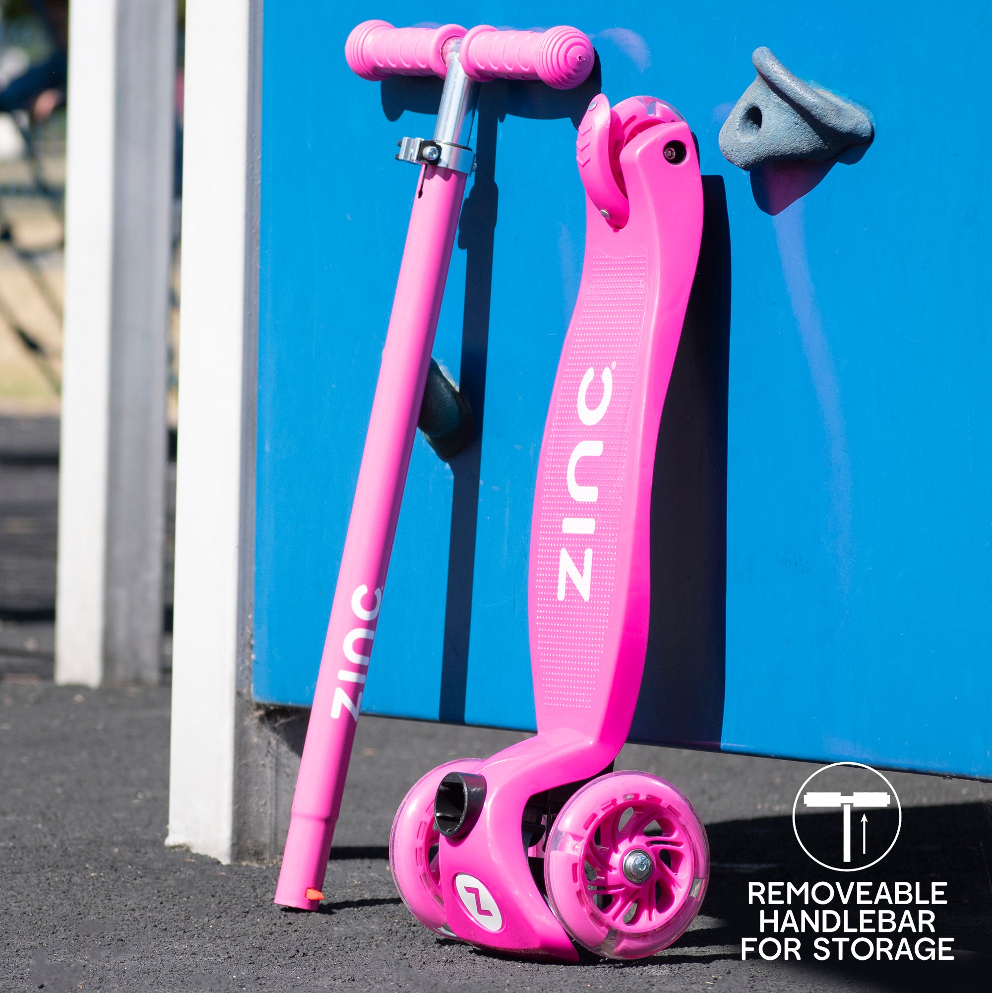 Zinc Three Wheeled Light Up Star Scooter disassembled showing base deck with three wheels separated from handlebar assembly