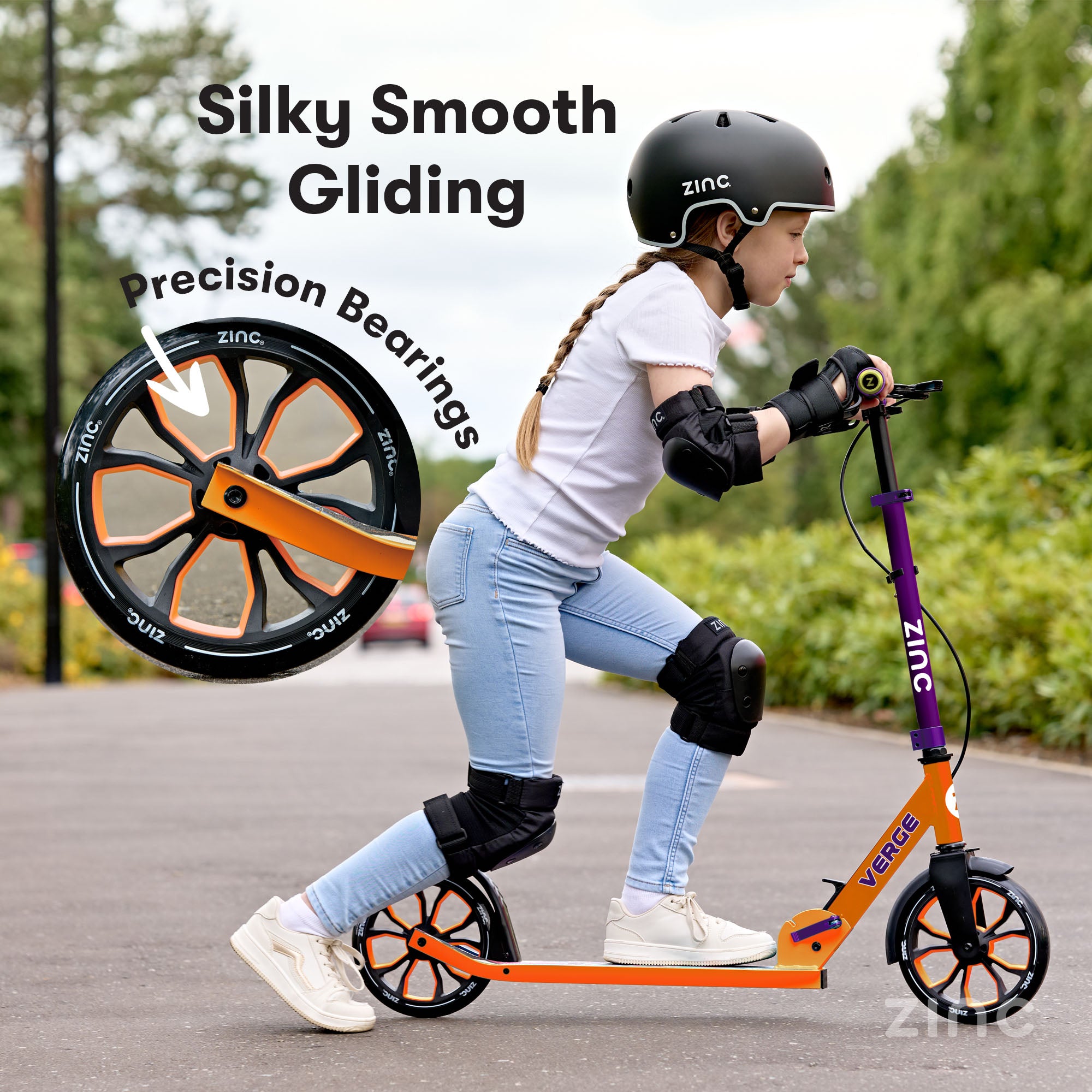 Child riding a scooter with 'Zinc' branding, wearing safety gear on a paved path. Highlighting precision bearings