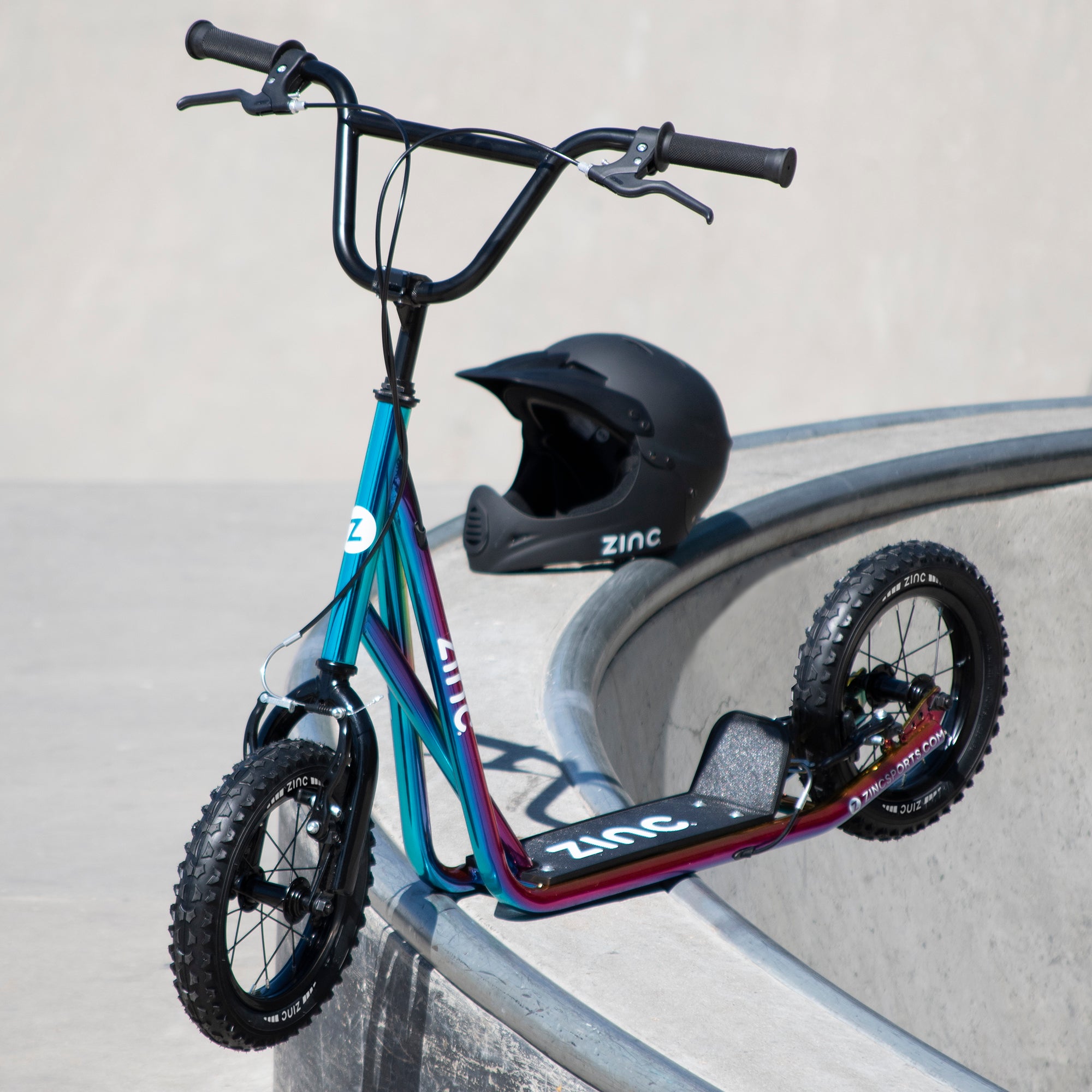 Zinc 12 Inch BMX Scooter Neochrome Multi-colour at Skate Park with Safety Helmet