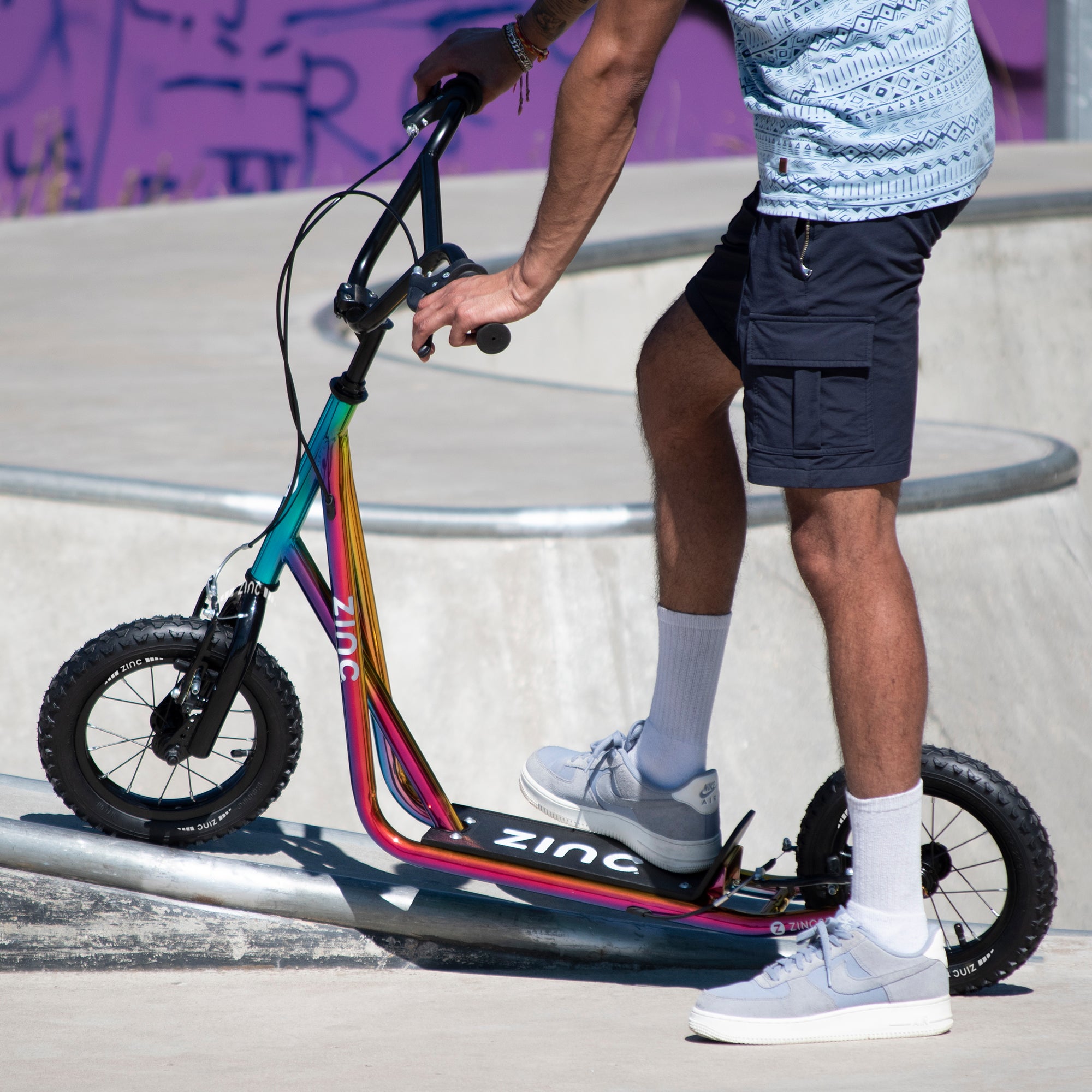 Young rider on Zinc 12 Inch BMX Scooter at Skate Park - Action Sports in Motion