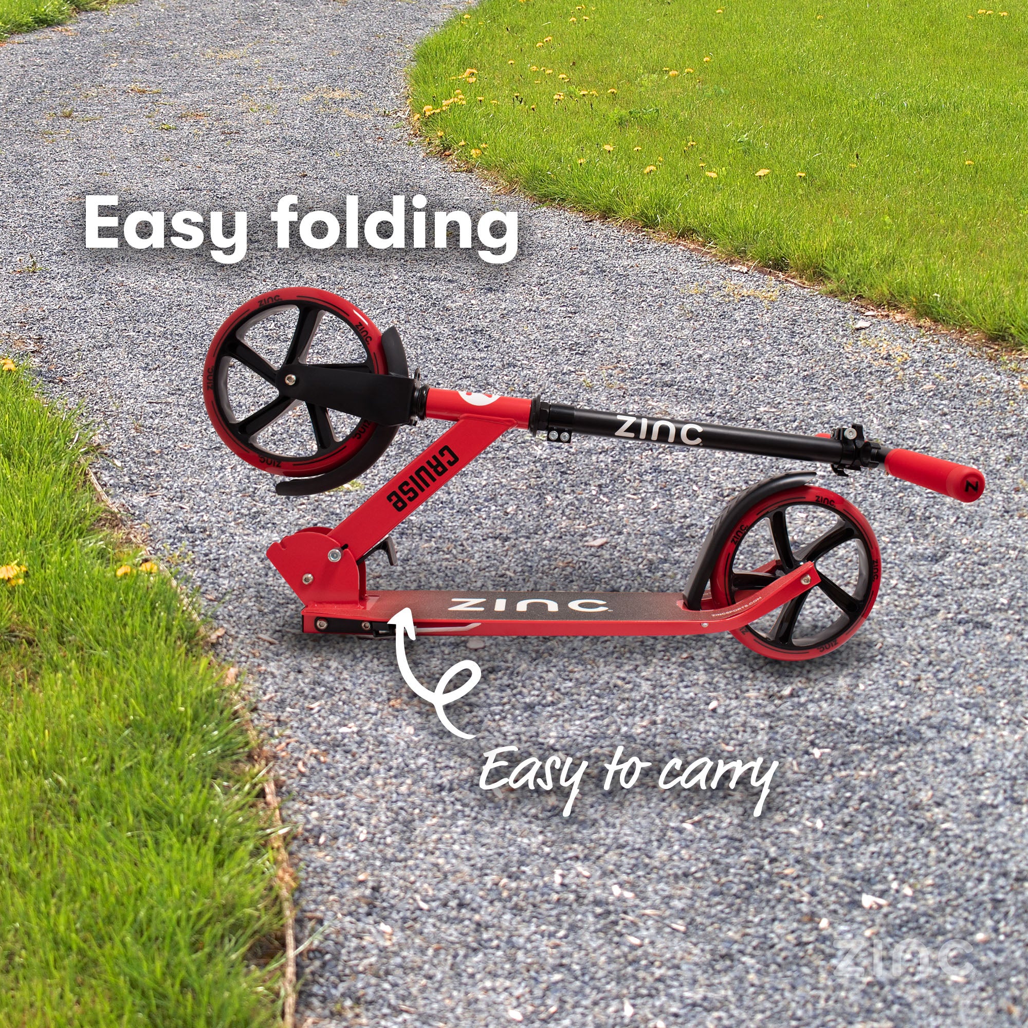 Zinc cruise big wheeled scooter in red demonstrating it's easy folding and easy to carry features 
