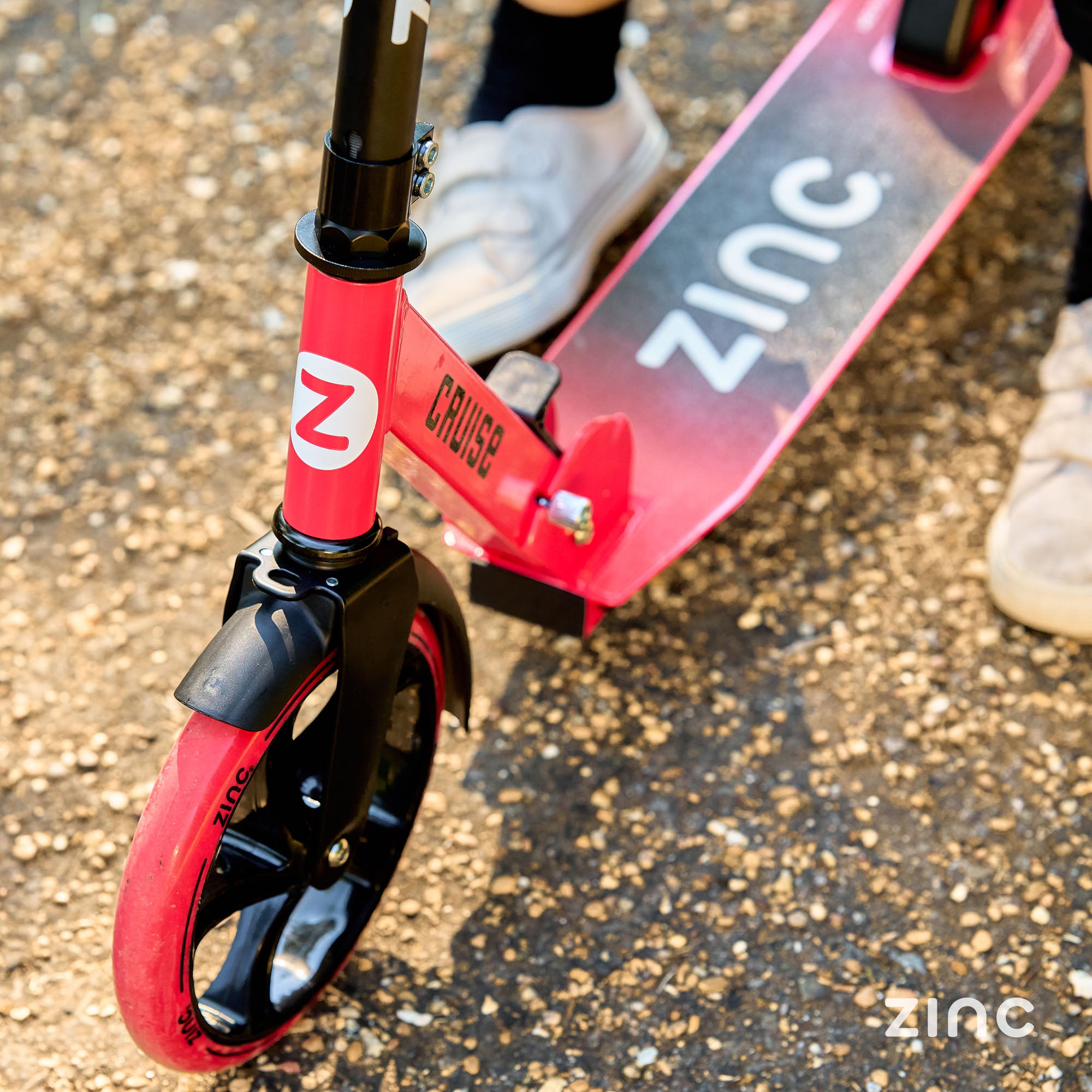 Close up of the Zinc printed grip tape on the red cruise scooter