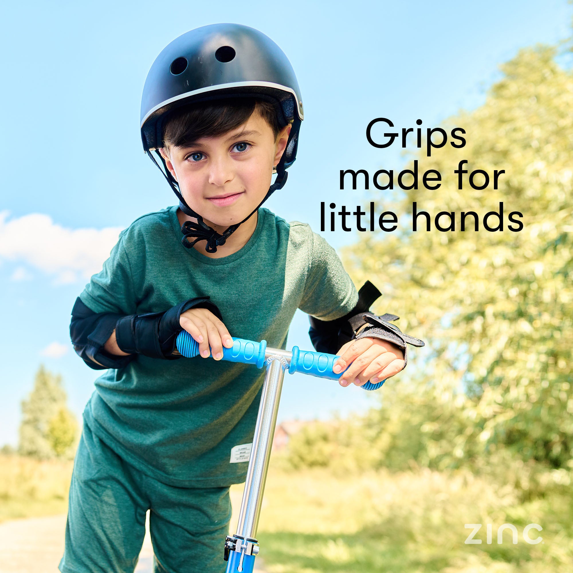 Boy on blue 3 wheel scooter showing soft grips for little hands