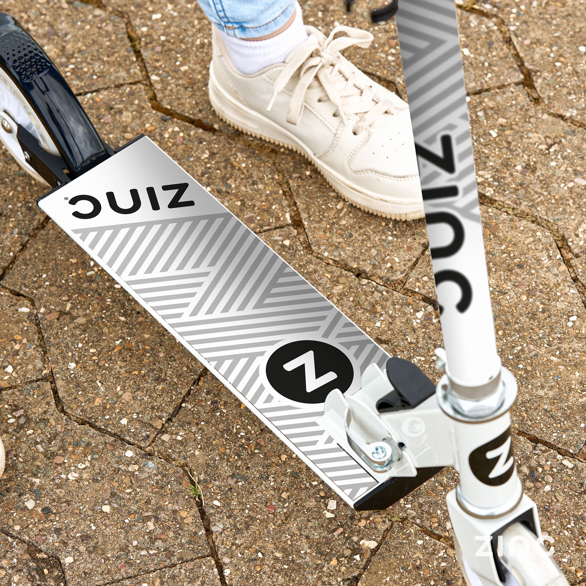 Anti-slip footplate on folding scooter providing secure footing and stability for safe riding