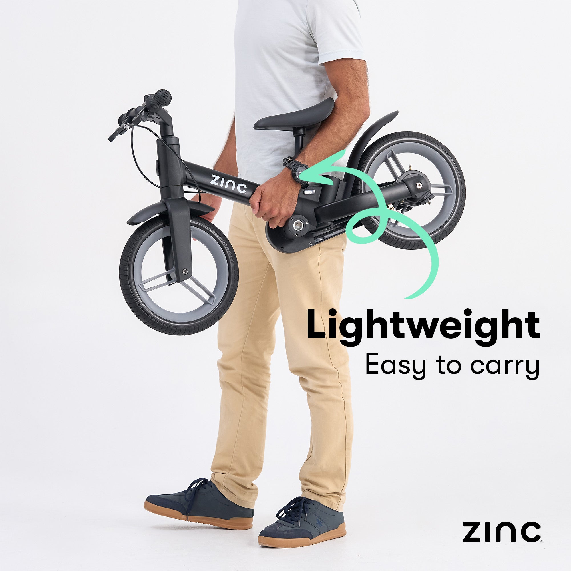Person holding the Zinc multifunctional trike emphasizing lightweight design.