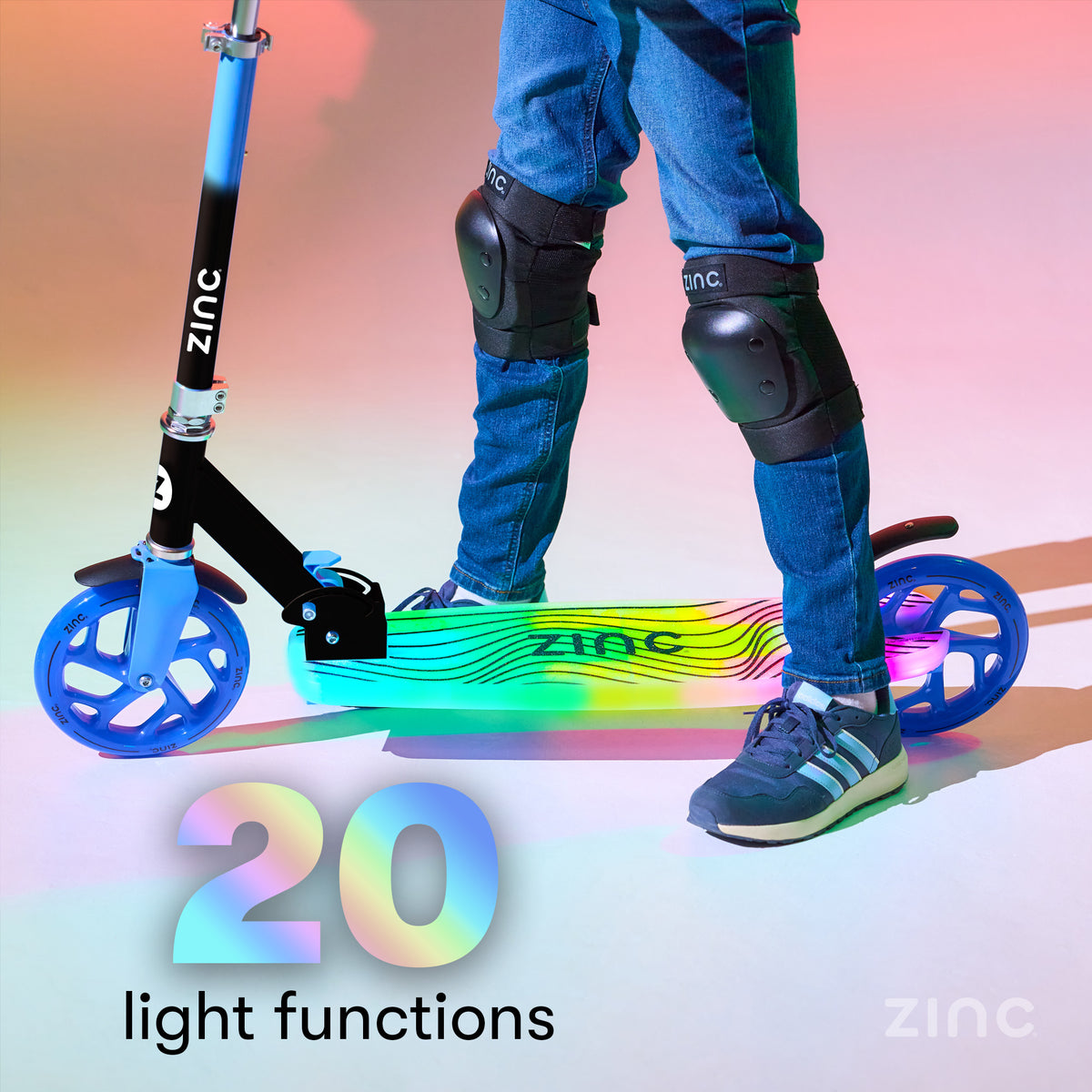 A child wearing blue jeans, black knee pads, and sneakers stands beside a blue and black zinc scooter with colorful illuminated wheels. Large text reads '20 light functions' and the zinc brand name is visible on the scooter and in the corner.