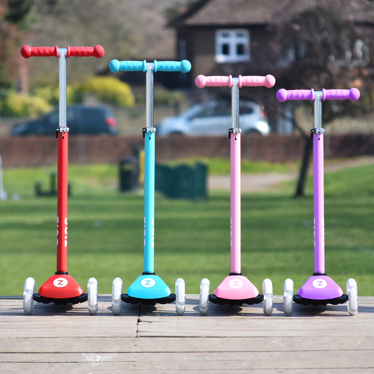 Red, blue, purple and pink Zinc Superstar non-folding scooter at different heights