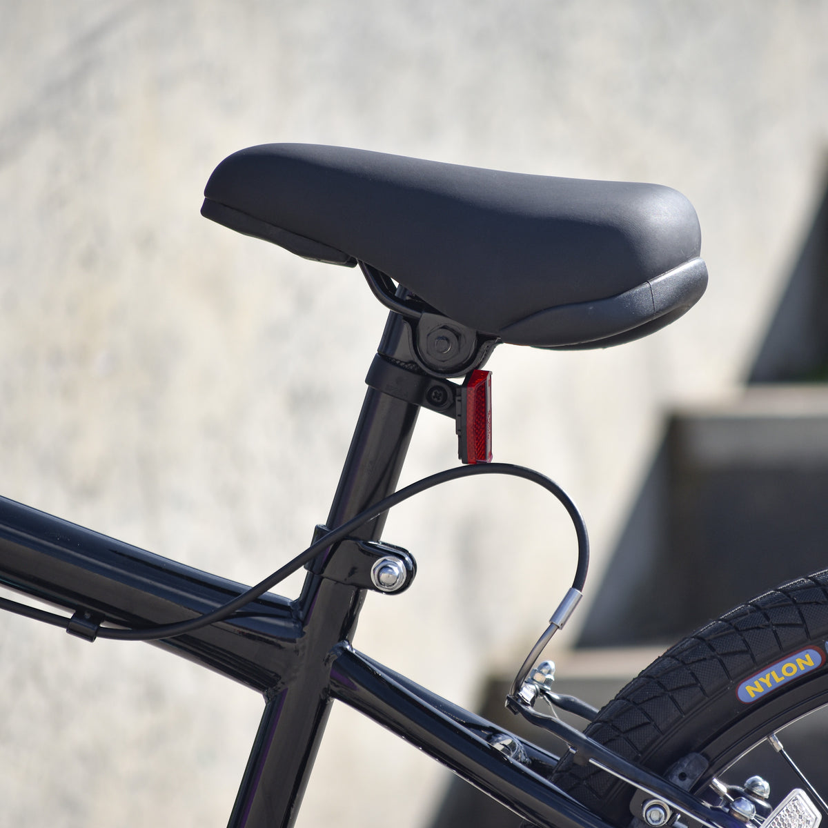 Close-up of ZINC Switch BMX bike seat and rear brake cable detail
