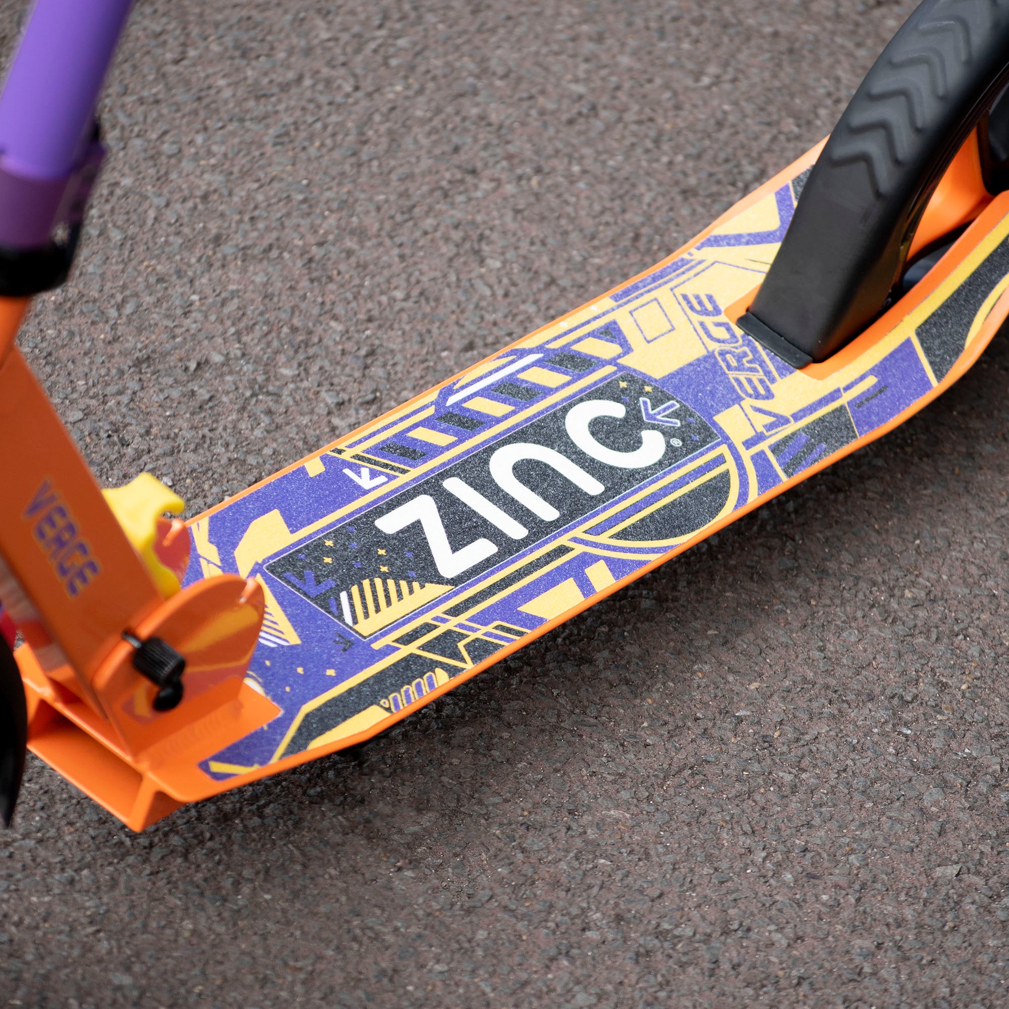 Zinc Verge Big Wheel Folding Scooter Orange Purple with close up of the wide grip plate and brake