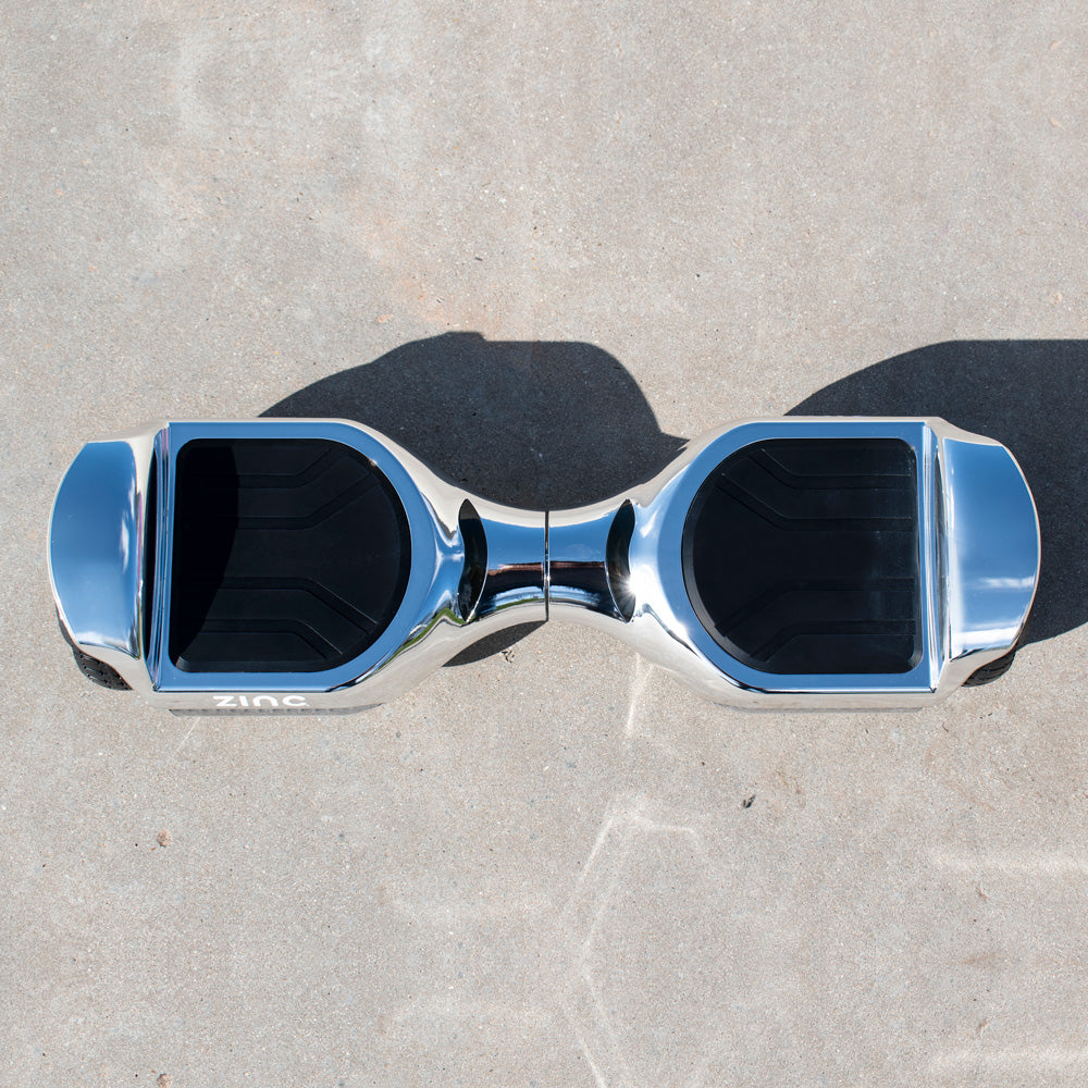 Zinc Megastar chrome hoverboard top view showing anti-slip foot pads and premium chrome finish design