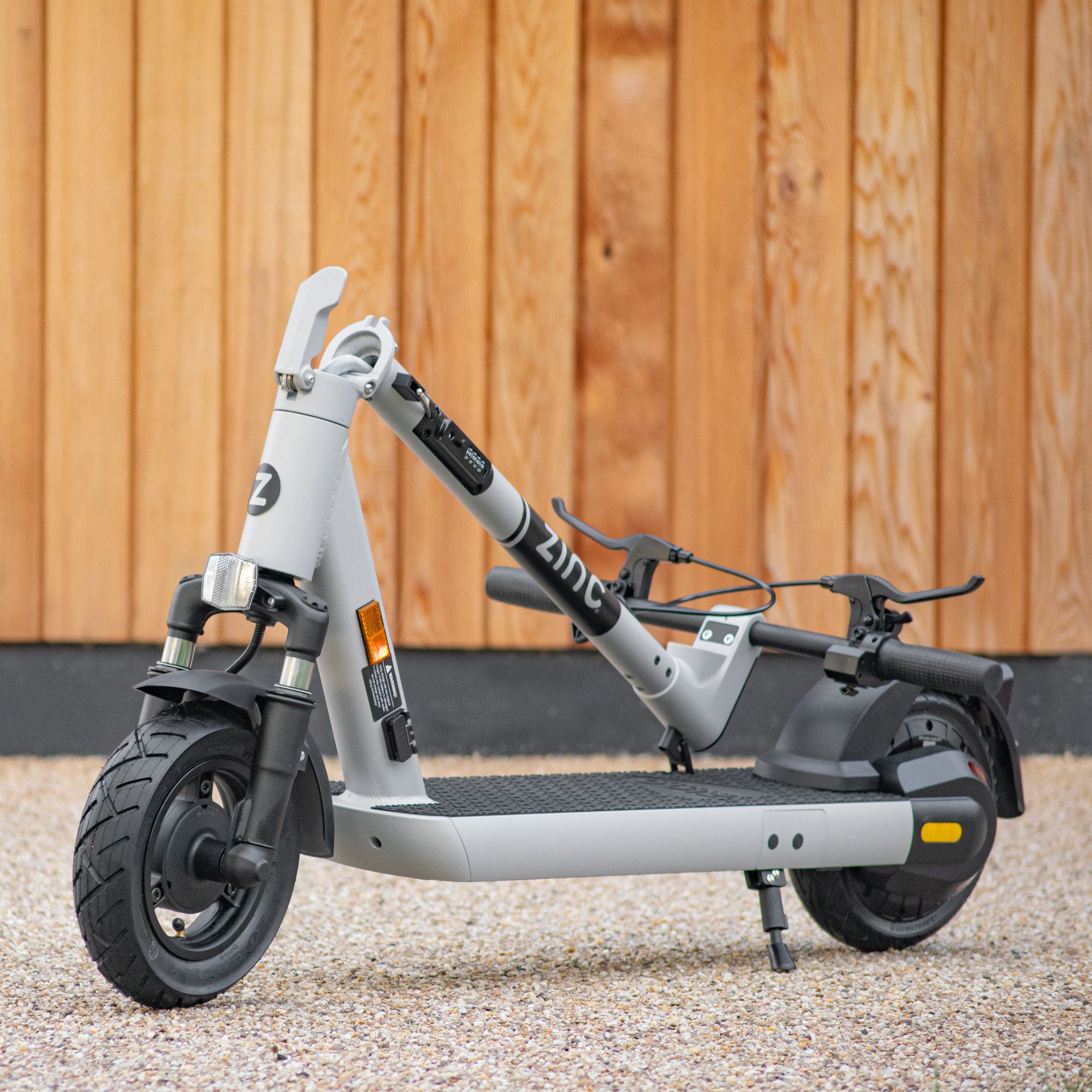 Folding electric scooter with rubber deck grip, built-in turning signals, and NFC card security system