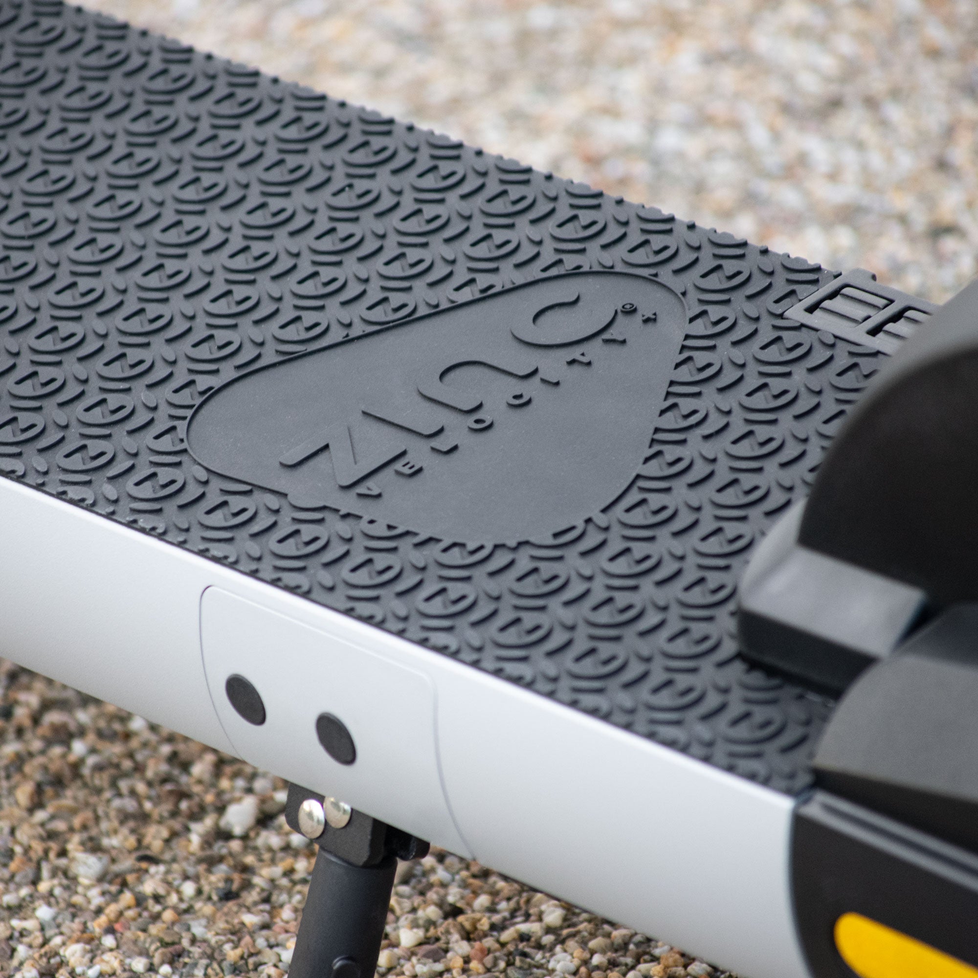 Folding electric scooter with rubber deck grip