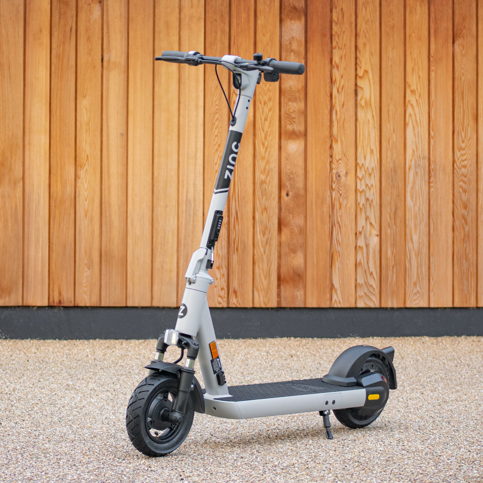 Adult electric scooter featuring 500W motor, dual suspension, and three speed modes up to 15.5mph
